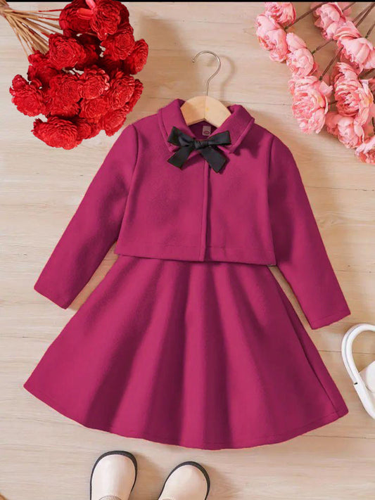 Dark pink long-sleeve dress with black bow collar and flared skirt