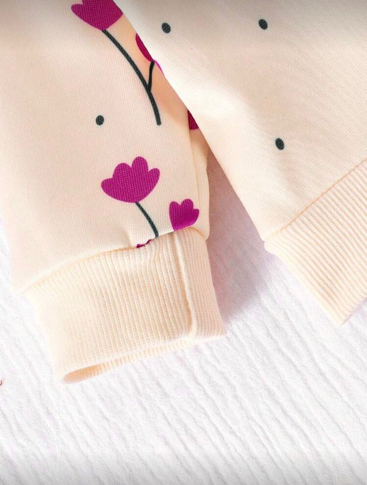 Cream sweatshirt sleeve with purple floral print and ribbed cuff