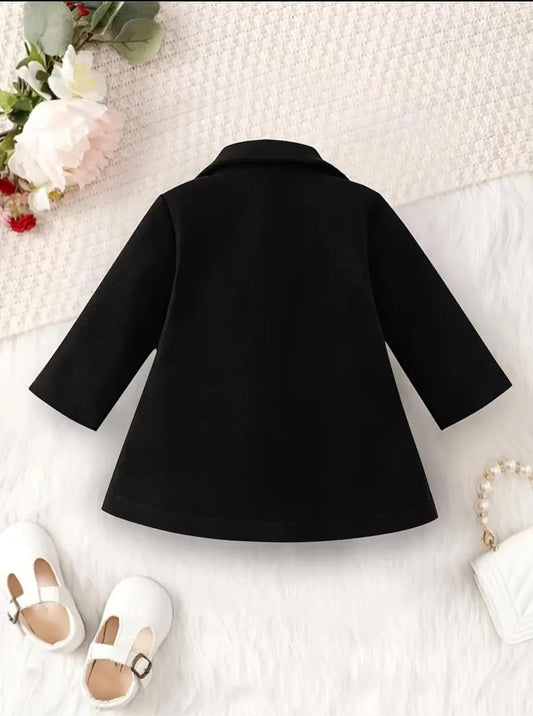 Black coat with wide back yoke and flared sleeves, knee-length